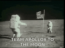 a black and white photo of two astronauts standing on the moon .