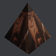 a picture of a man with glasses and a mustache is in a pyramid