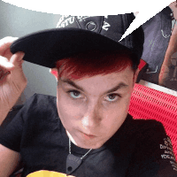 a person with red hair is wearing a black hat that says nz