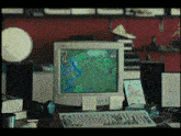 a computer monitor with a map on the screen and a keyboard