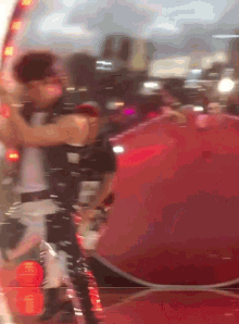 a blurry picture of a person standing in front of a red umbrella