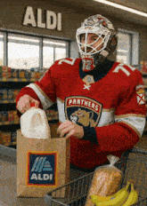a hockey player wearing a panthers jersey is shopping at aldi
