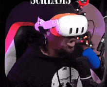 a man wearing a virtual reality headset and holding a microphone