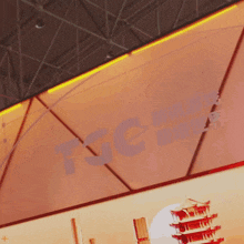 a sign that says tsc on it with a picture of a pagoda in the background