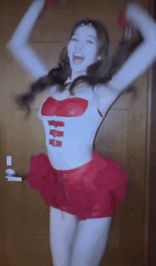 a woman in a red and white outfit is dancing with her arms in the air