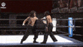 two men are wrestling in a ring with a sign that says idlpro