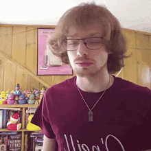 a man wearing glasses and a purple shirt that says lisa 's on it