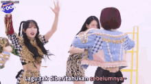 a group of girls are dancing in front of a sign that says k-dol on it