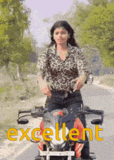 a woman is riding a motorcycle on a road and the word excellent is on the bottom