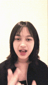 a girl with short hair is making a funny face with her mouth open
