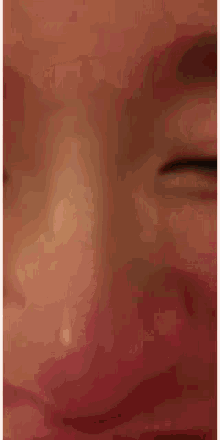 a close up of a person making a funny face with their mouth open and their eyes closed .