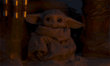 a stuffed animal with a scarf around its neck is sitting in a dark room