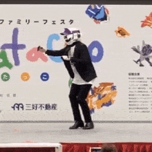 a man in a suit and helmet is dancing in front of a taco sign
