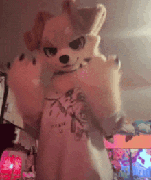 a person in a furry costume is standing in a room with a t-shirt on .