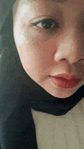 a close up of a woman wearing a hijab