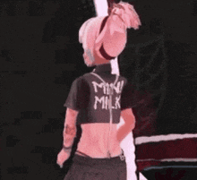 a girl with pink hair is wearing a black shirt that says milk