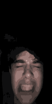 a blurry picture of a man 's face with a black background