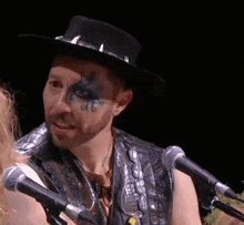 a man wearing a hat has a tattoo on his face that says ' a '