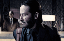 a man in a suit and tie has a beard