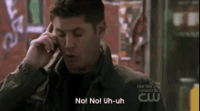 a man is talking on a cell phone and says no