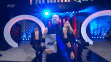 a group of aew wrestlers are walking down a stage