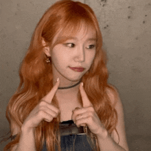 a woman with long red hair is making a face