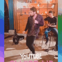 a man is playing a guitar while another man is dancing in front of a youtube logo