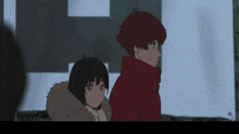 a boy and a girl are standing next to each other in a dark room