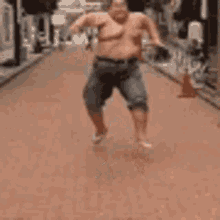 a very fat man is running down a street .