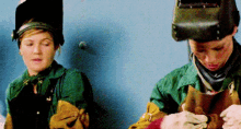 a man and a woman wearing welding helmets