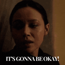 a woman says " it 's gonna be okay " in front of a window
