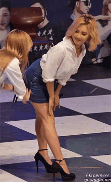 two women are standing on a checkered floor with the words happiness cp-studio.net on the bottom right