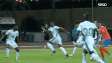 soccer players on a field with ssc written on the bottom right