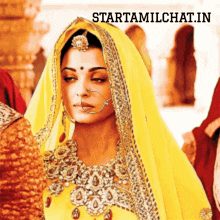 a woman wearing a yellow veil with the words starttamilchat.in above her