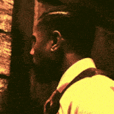 a man in a suit and tie stands in front of a wooden wall