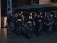 a group of women are dancing in front of a sign that says keep teeth on it