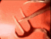 a red background with a hook in the middle