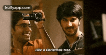 a man taking a picture of another man with a camera .