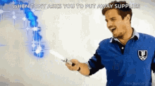 a man in a blue shirt is holding a knife in his right hand .