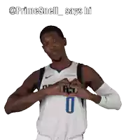 a basketball player with the number 0 on his jersey making a heart shape