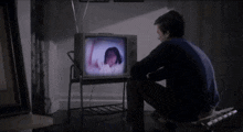 a woman in a bathrobe is dancing on a tv screen