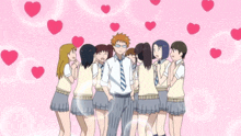 a group of people are standing around a man in a tie with hearts floating around him