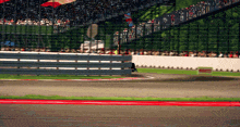 a race track with a fence and a sign that says ' racing ' on it