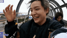 a man riding a roller coaster with a sign that says ' journey ap ' on it