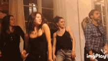 a group of people are dancing in a room with the words imgplay in the bottom right corner