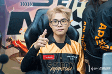 a man wearing glasses and a saigon jersey