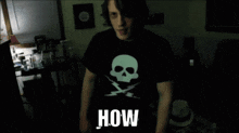 a man wearing a black t-shirt with a skull and lightning bolt on it says how