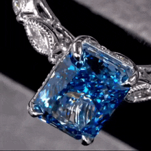 a close up of a ring with a blue stone in it