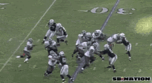 a football player is being tackled by another player on the field