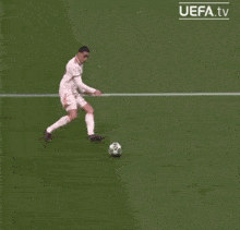 a soccer player with the number 12 on his jersey kicking the ball